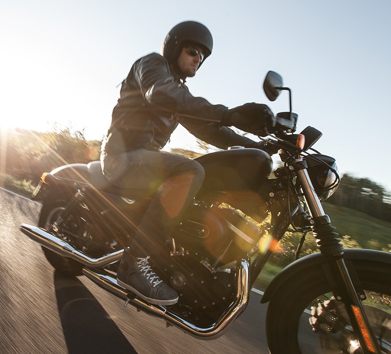 Guy riding motorcycle wearing open face helmet